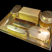            A 9ct gold dressing table set. Hammer: £11,000